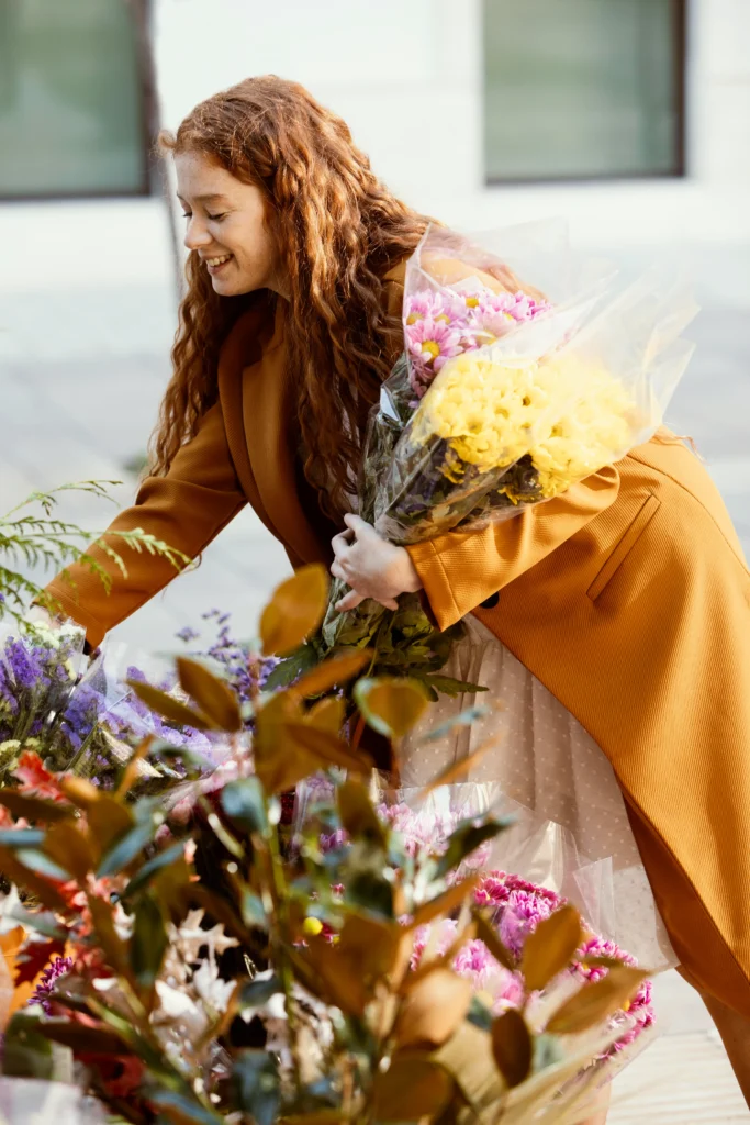 side view smiley woman choosing spring flowers bouquet